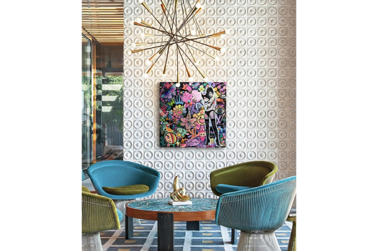Modern interior with colorful chairs, a table, and decorative wall art against a patterned wall.
